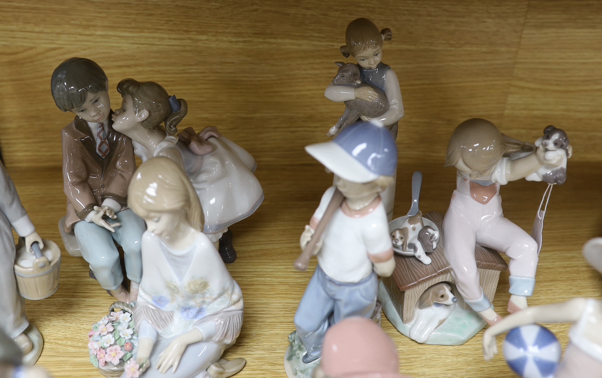 Ten Lladro figures of children, tallest girl with lamb 22cm high